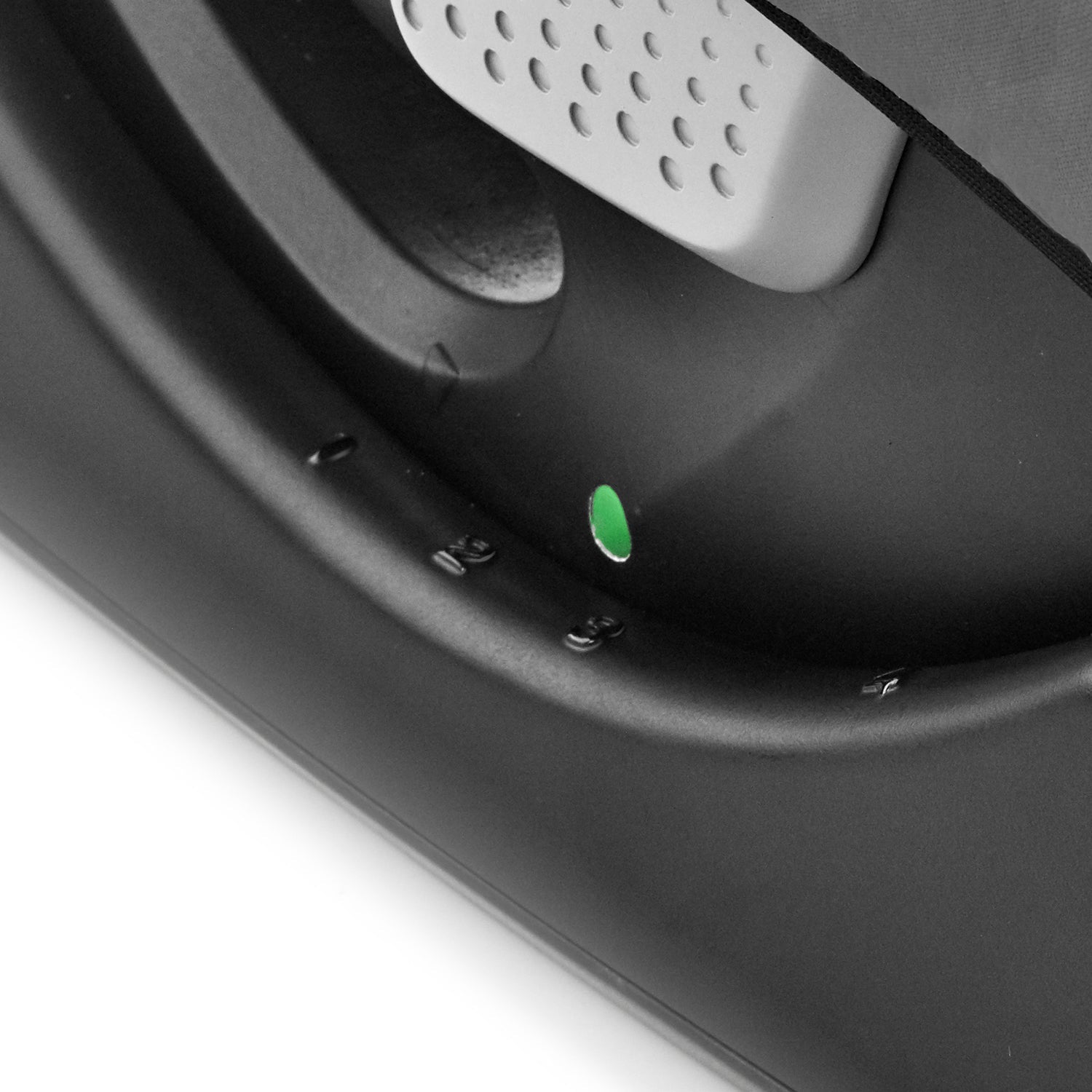 Close-up of a stroller brake with a green indicator light on a white background