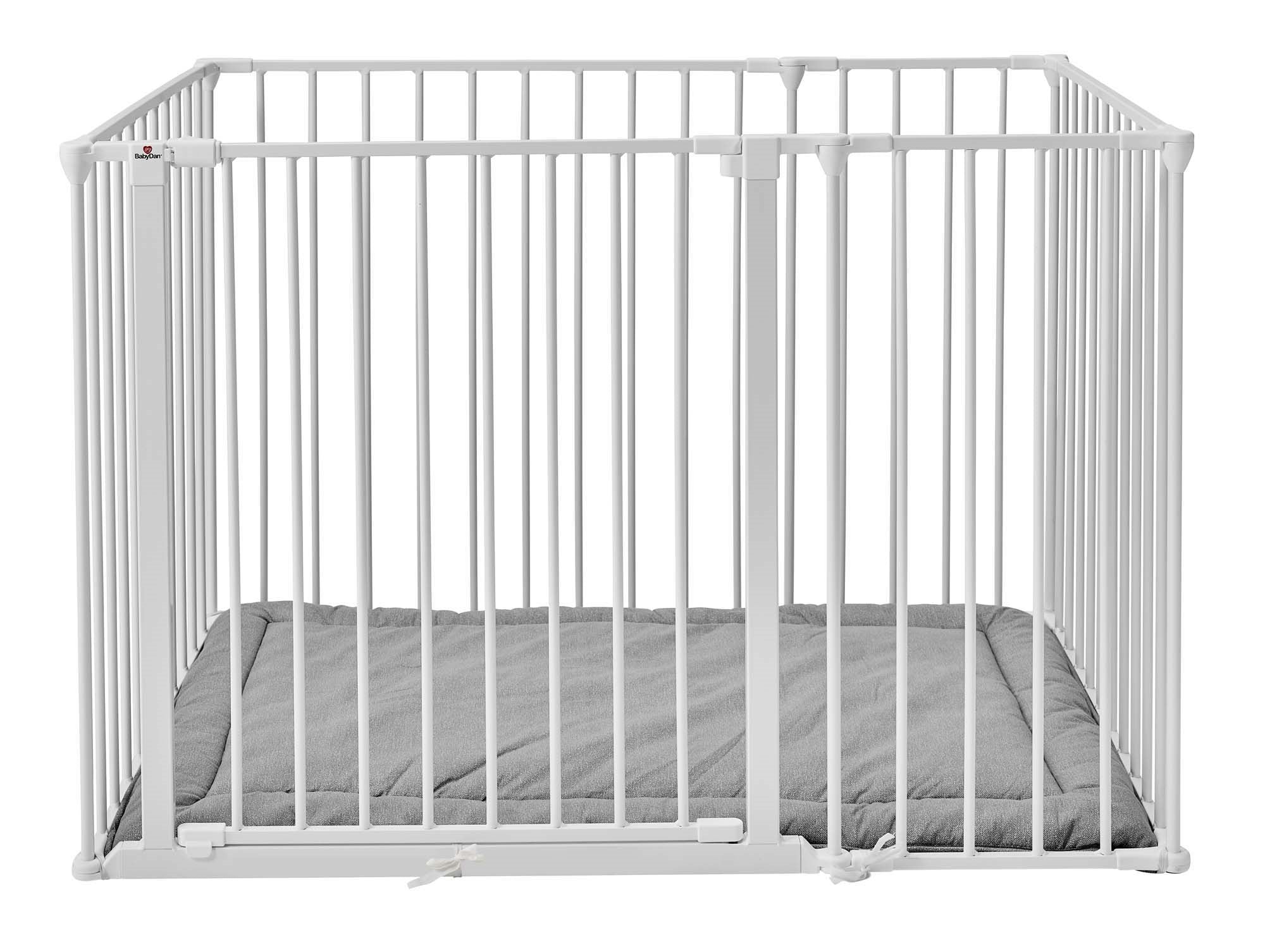 White metal crib with a gray mattress on a white background