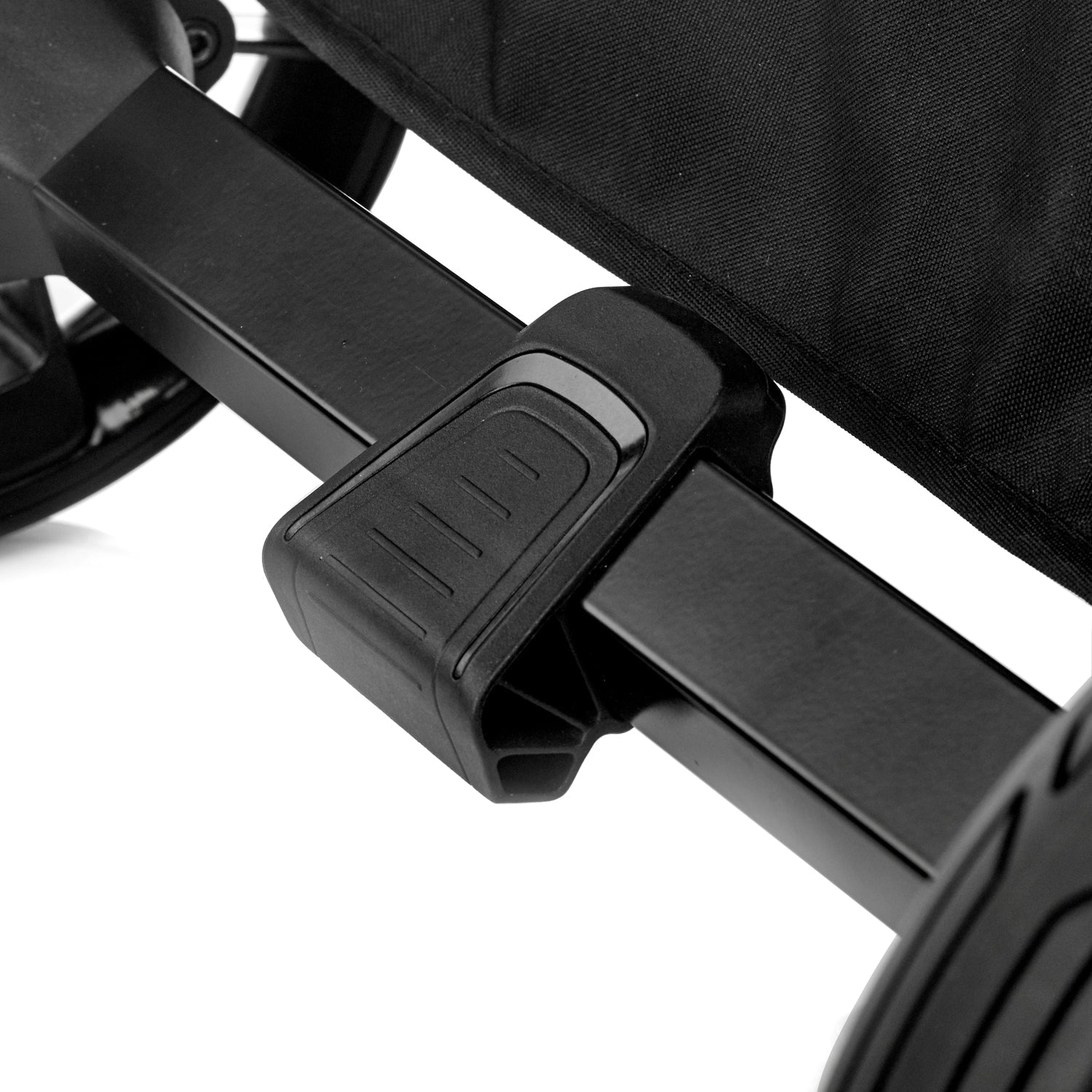 Close-up of a black stroller brake with a white background