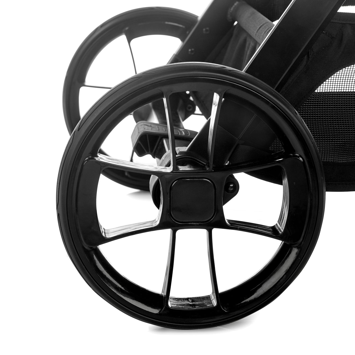 Close-up of a black stroller wheel on a white background
