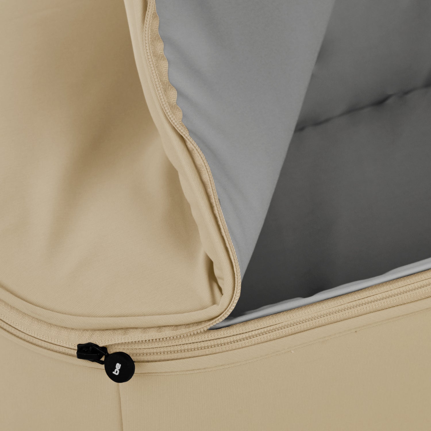 Close-up of a beige and gray fabric with a zipper detail