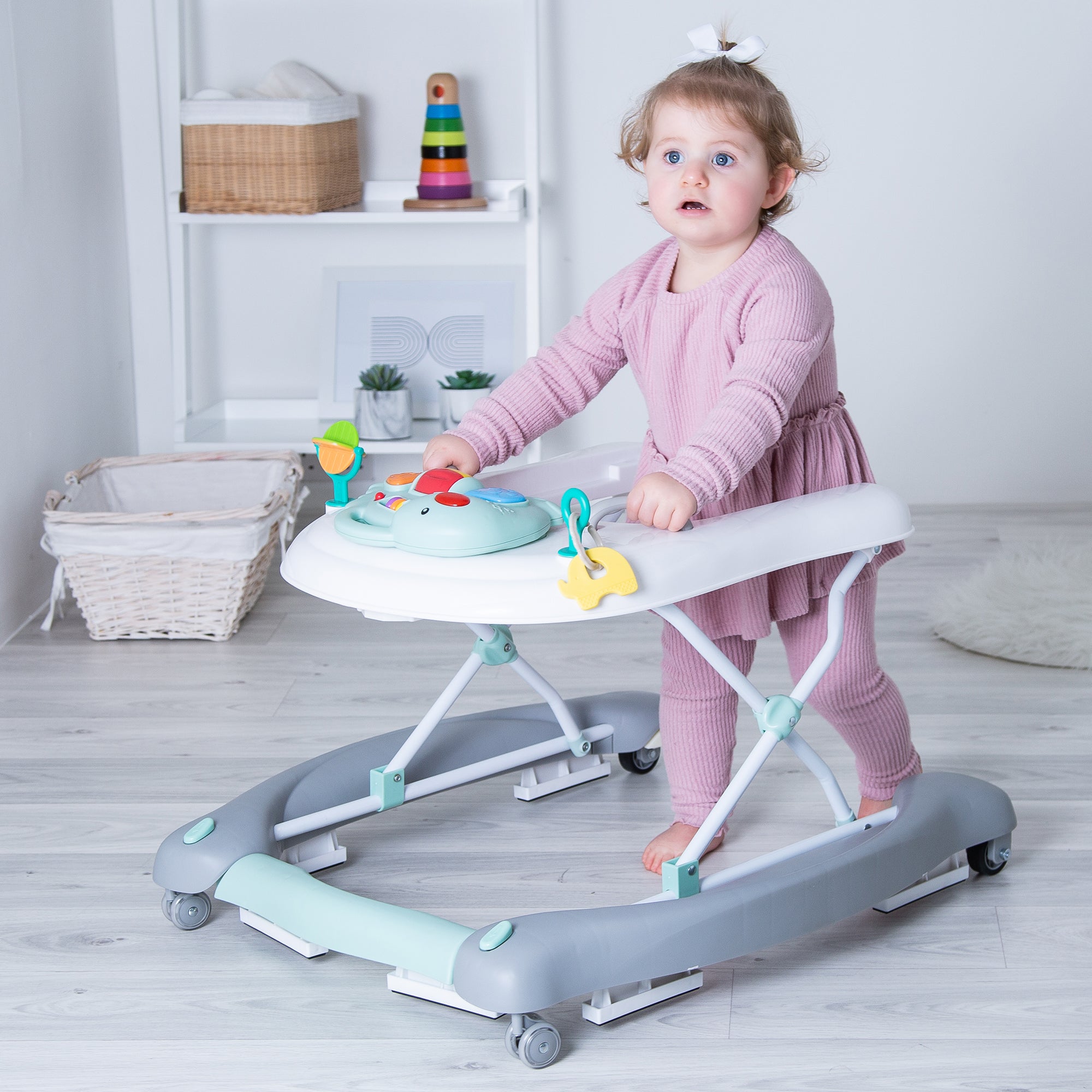 Child using a baby walker in a room with a shelf in the background