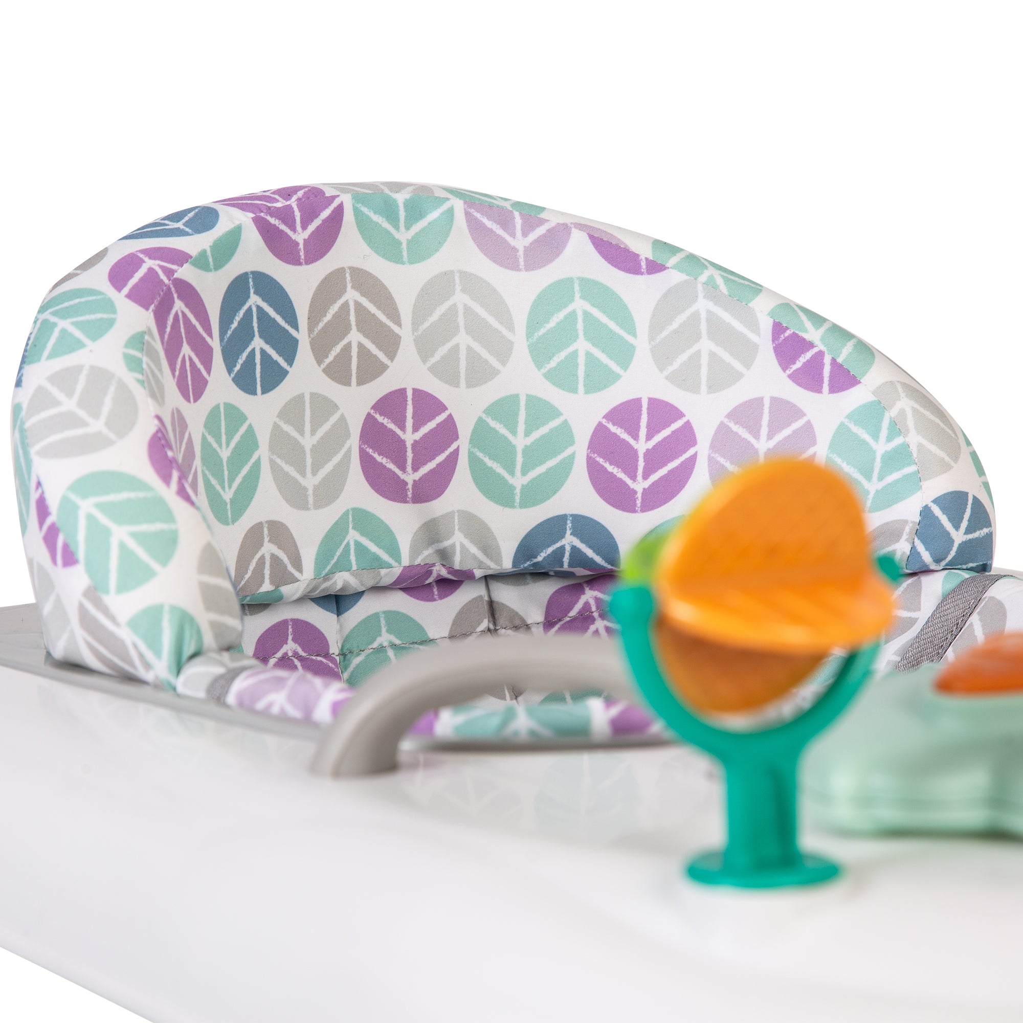 Baby walker with leaf pattern and a green toy on a white background