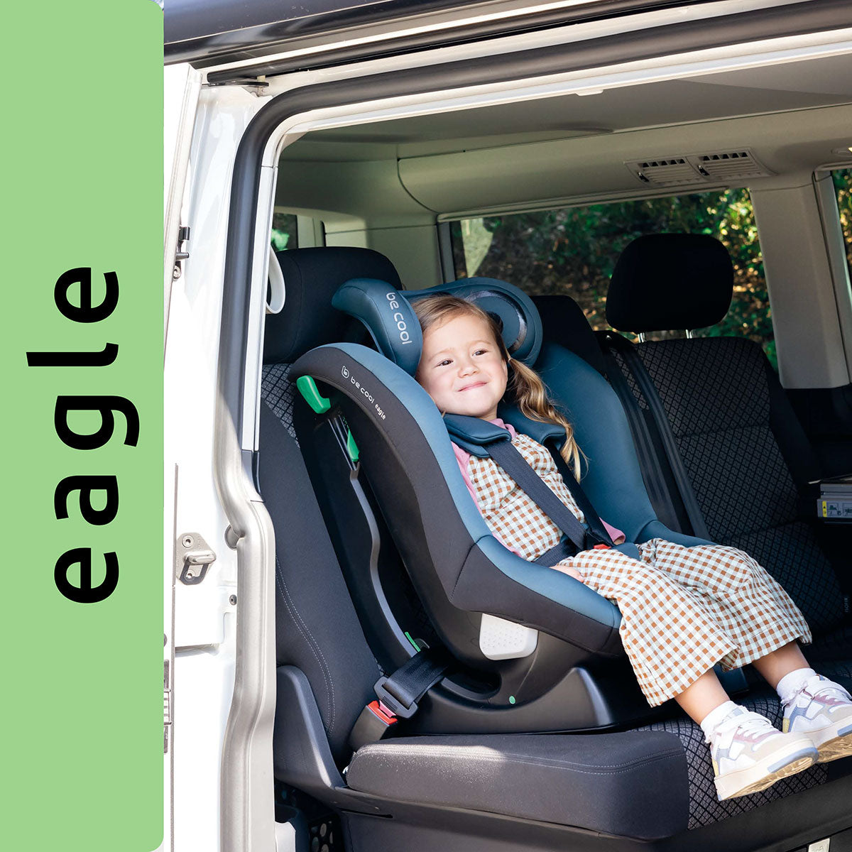 Child in a car seat with 'eagle' branding on a green background