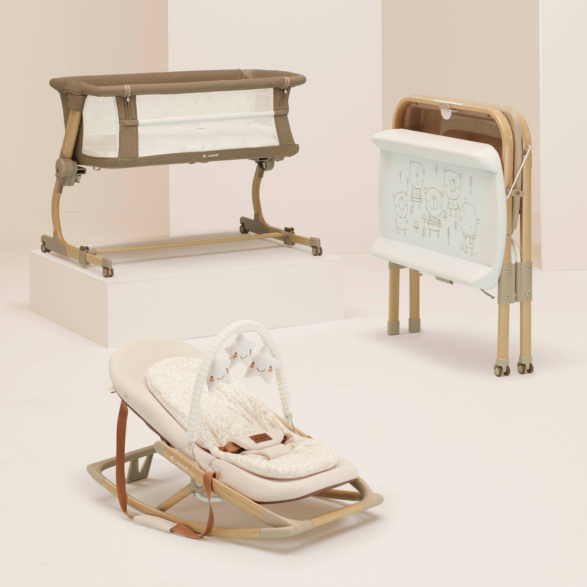 Three baby products including a crib, bouncer, and rocker on a light background