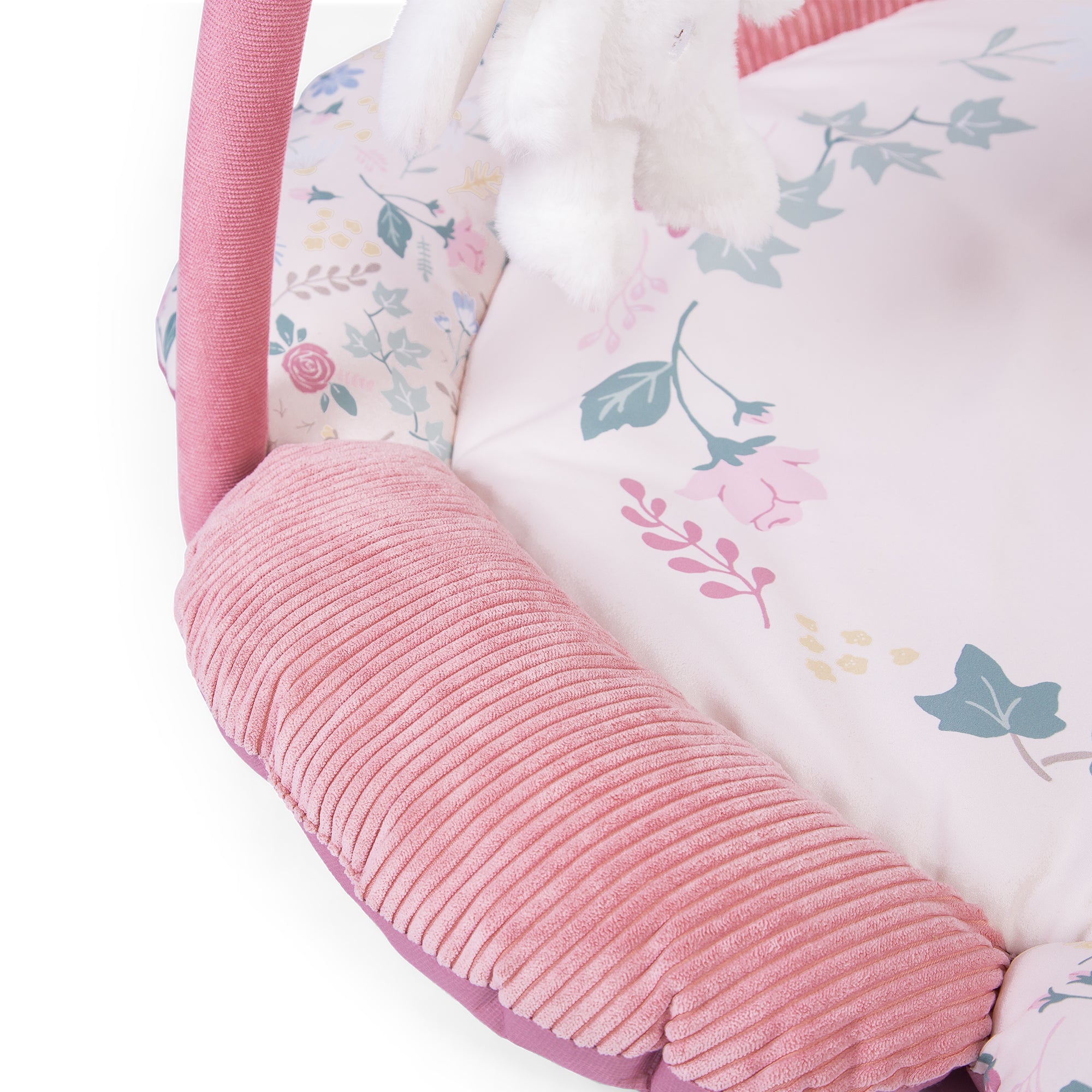 close up Floral-patterned baby playgym with pink corduroy texture