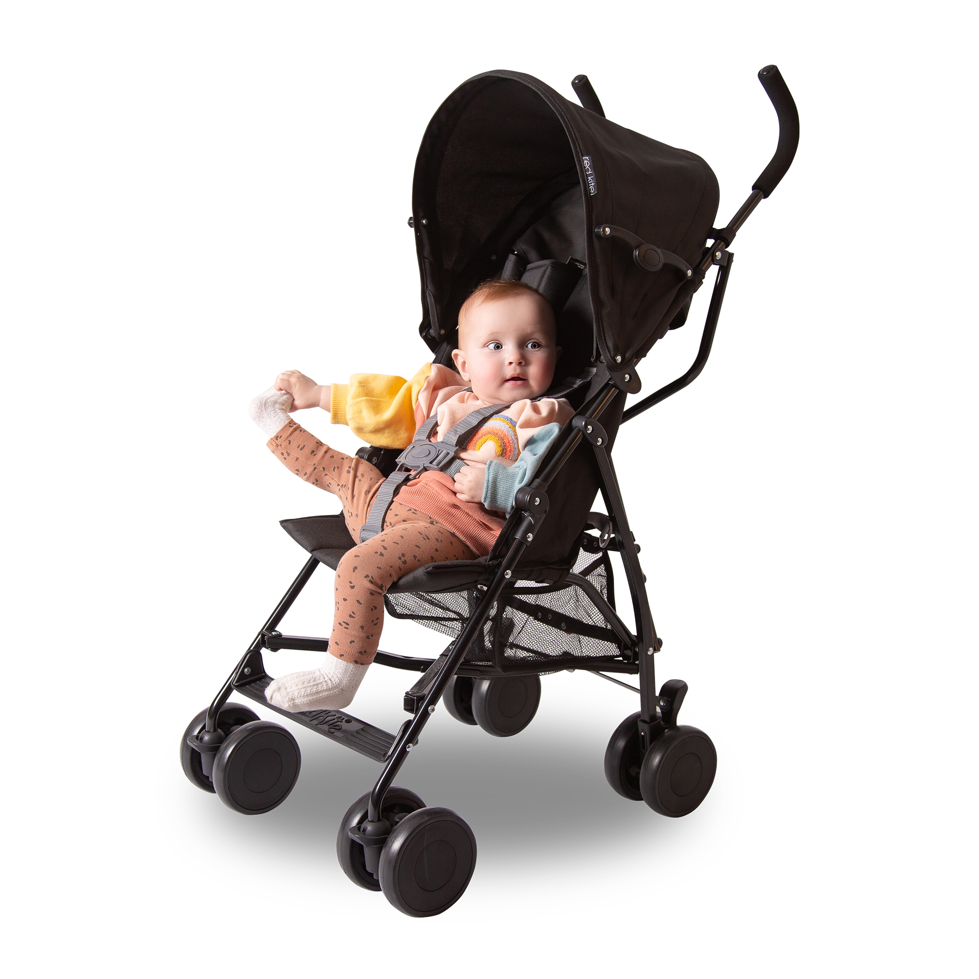Baby in a black stroller on a white background