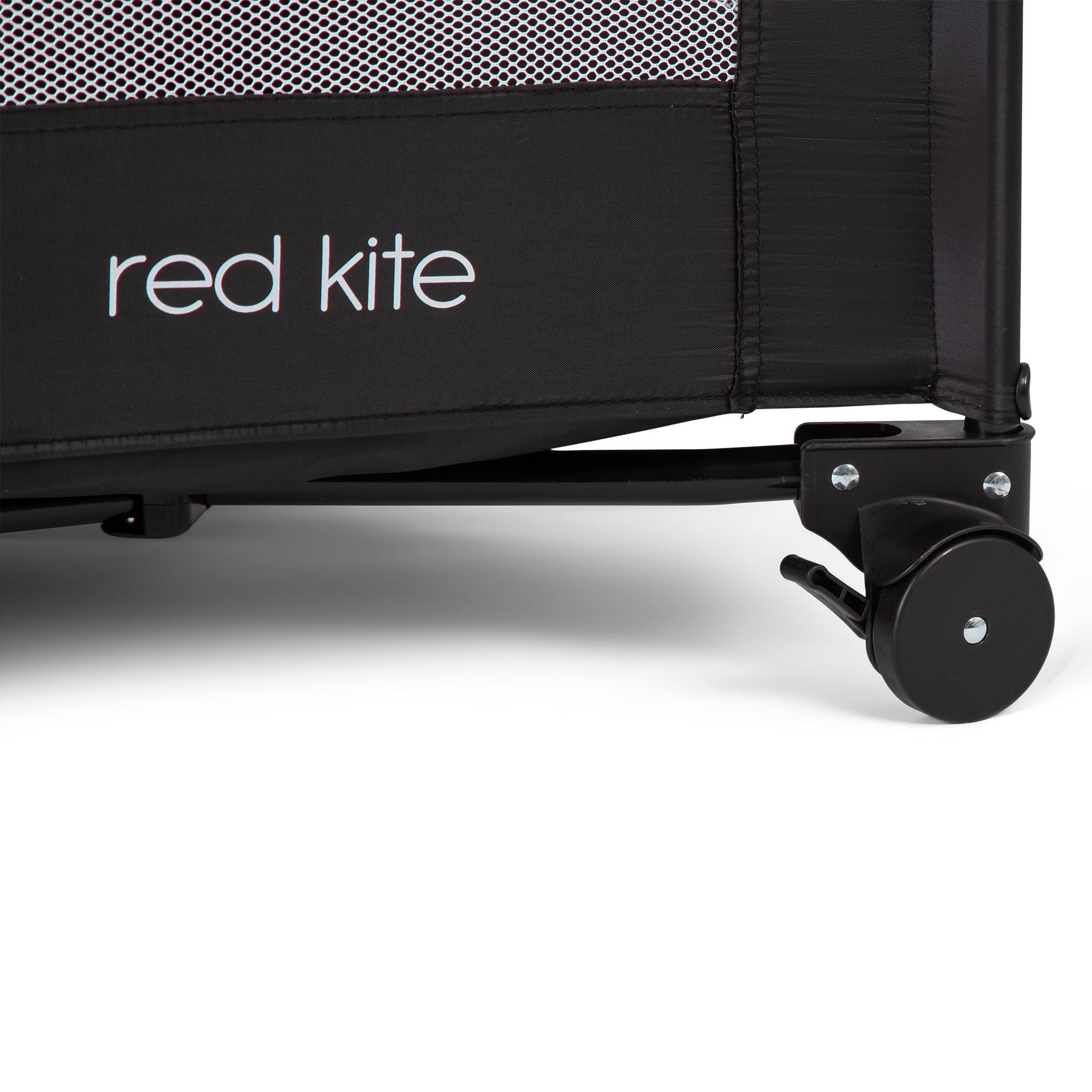 Close-up of a black crib with 'red kite' branding on a white background